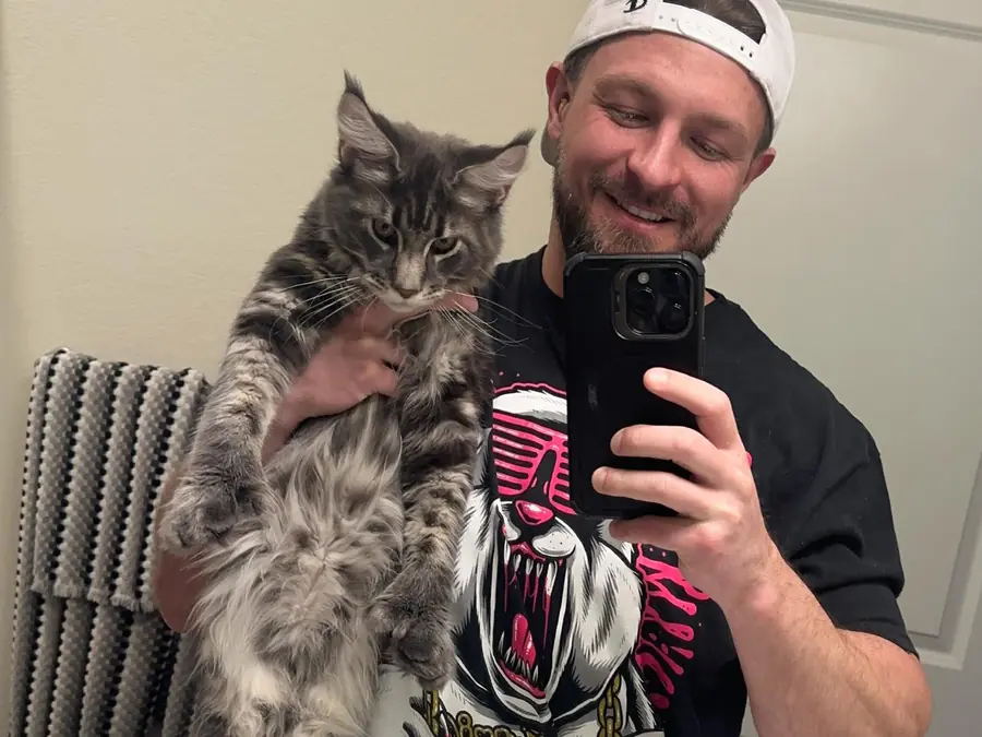 Dean, a smoke tabby Maine Coon from Cass Coon Cats, held up by his owner in Ohio to show his size